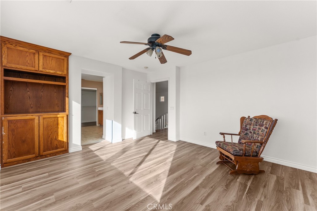 9749 Orange Street Rancho Cucamonga, CA 91737 - Photo 22 of 38 a bedroom with a bed and wooden floor