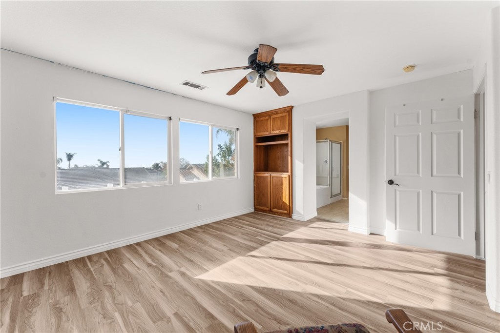 9749 Orange Street Rancho Cucamonga, CA 91737 - Photo 23 of 38 a view of empty room with wooden floor and ceiling fan