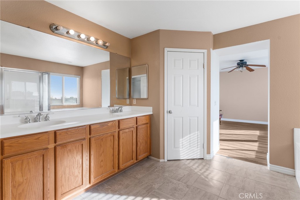9749 Orange Street Rancho Cucamonga, CA 91737 - Photo 25 of 38 a bathroom with a double vanity sink and a mirror
