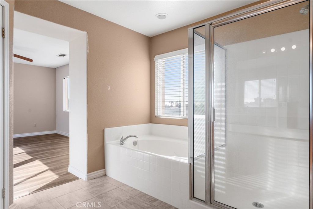 9749 Orange Street Rancho Cucamonga, CA 91737 - Photo 26 of 38 a bathroom with a bathtub and a shower