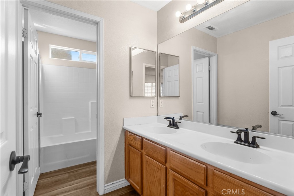 9749 Orange Street Rancho Cucamonga, CA 91737 - Photo 29 of 38 a bathroom with 2 sink and a mirror