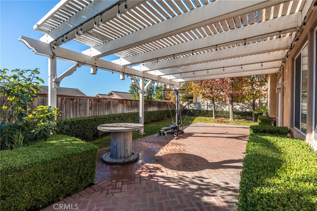 9749 Orange Street Rancho Cucamonga, CA 91737 - Photo 31 of 38 a view of a backyard with table and chairs potted plants and large tree