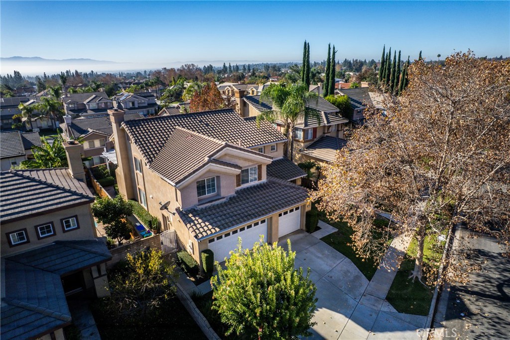 9749 Orange Street Rancho Cucamonga, CA 91737 - Photo 38 of 38 a view of a house with a yard and a mountain in the background