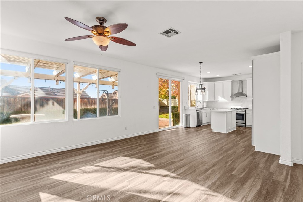 9749 Orange Street Rancho Cucamonga, CA 91737 - Photo 9 of 38 a view of a kitchen with wooden floor and a window