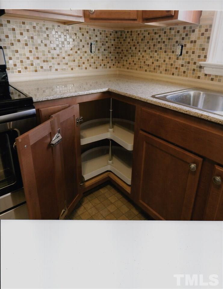 8200 Bellingham Circle Raleigh, NC 27615 - Photo 3 of 7 a kitchen with a refrigerator and cabinets