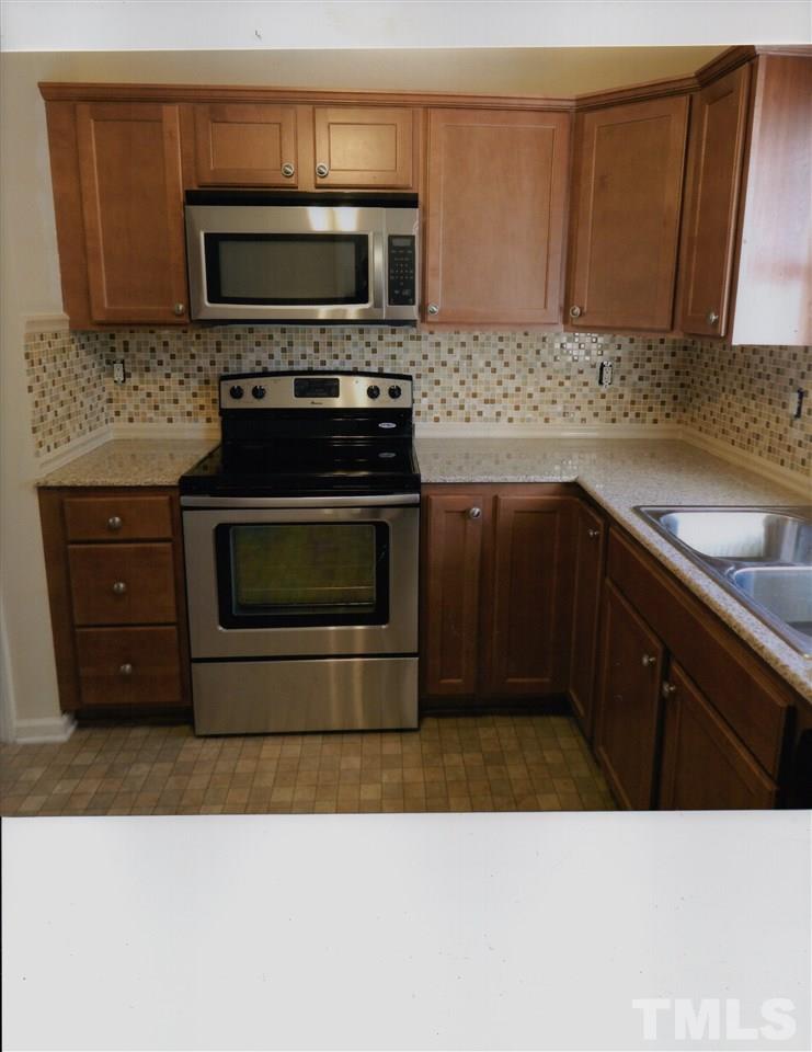 8200 Bellingham Circle Raleigh, NC 27615 - Photo 7 of 7 a kitchen with a stove microwave and sink