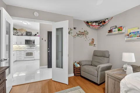 a living room with furniture and a painting on the wall