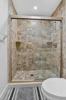 a bathroom with a toilet and a shower