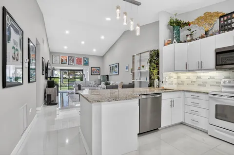 a kitchen with stainless steel appliances granite countertop a stove and cabinets