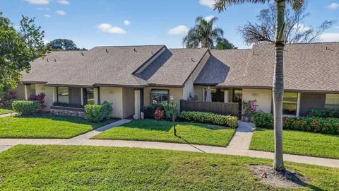 a front view of a house with yard patio and green space