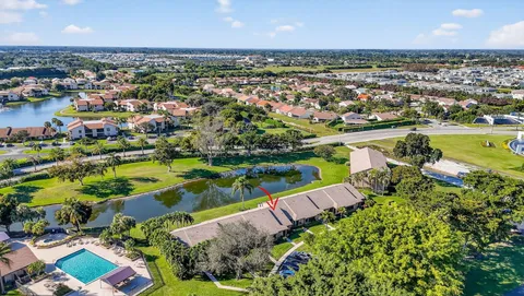 an aerial view of a city with lots of residential buildings ocean and mountain view in back