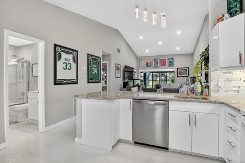 a kitchen with cabinets and refrigerator
