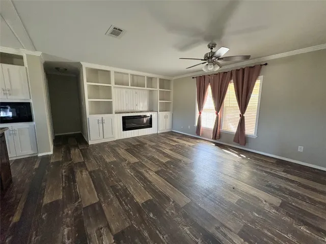 wooden floor in an empty room with a fireplace