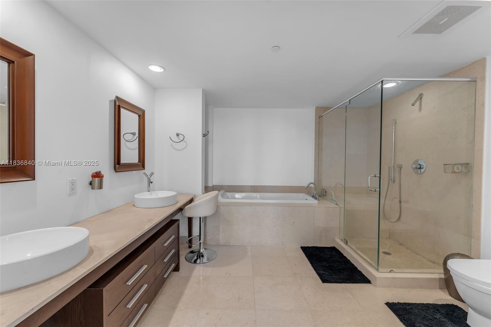 495 Brickell Avenue, Unit BAY1007 Miami, FL 33131 - Photo 15 of 34 a bathroom with a sink a toilet a mirror and shower