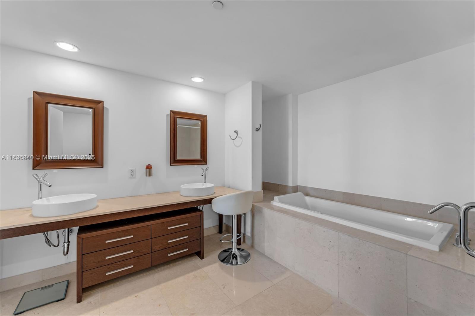 495 Brickell Avenue, Unit BAY1007 Miami, FL 33131 - Photo 17 of 34 a bathroom with a tub sink and mirror