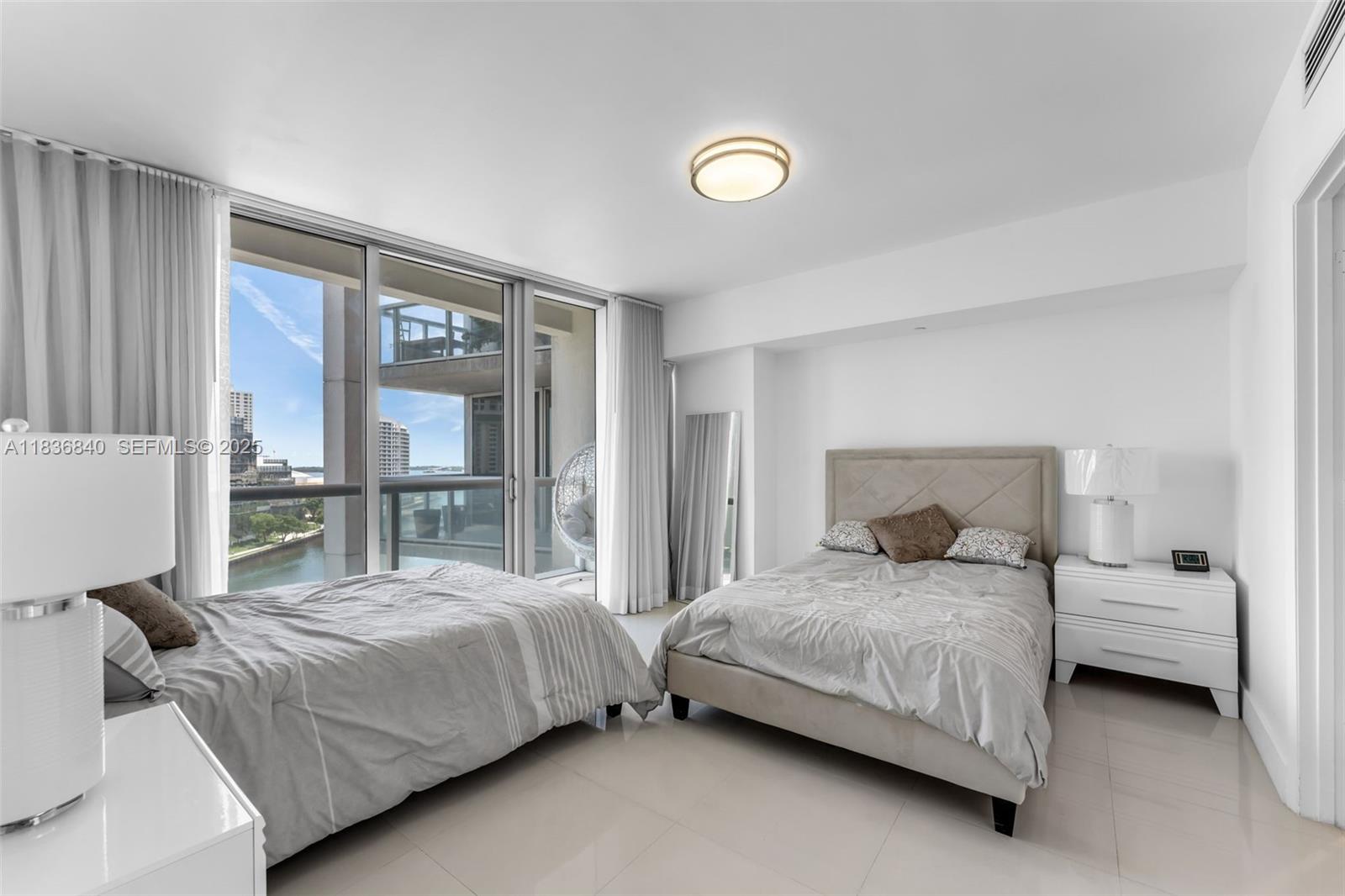 495 Brickell Avenue, Unit BAY1007 Miami, FL 33131 - Photo 18 of 34 a bedroom with a bed and a large window