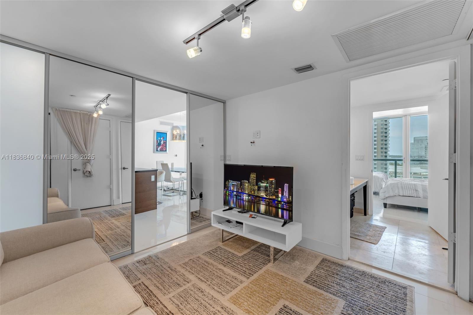 495 Brickell Avenue, Unit BAY1007 Miami, FL 33131 - Photo 21 of 34 a living room with furniture and a wooden floor