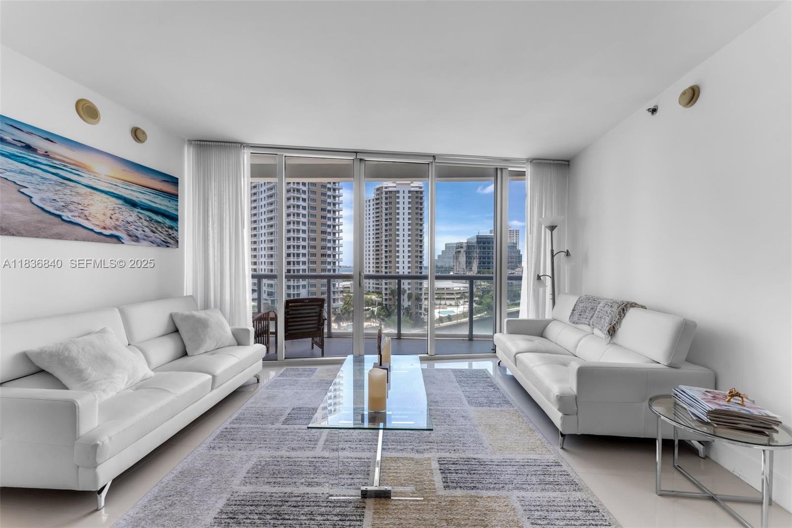 495 Brickell Avenue, Unit BAY1007 Miami, FL 33131 - Photo 7 of 34 a living room with furniture and a fireplace