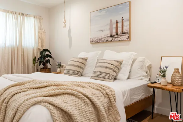 a bedroom with a bed and a mirror
