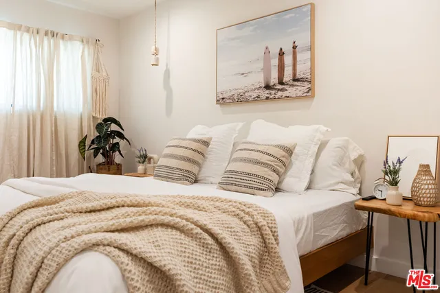 a bedroom with a bed and a mirror