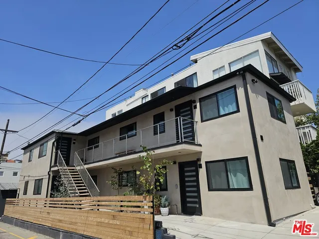 a view of a house with car parked