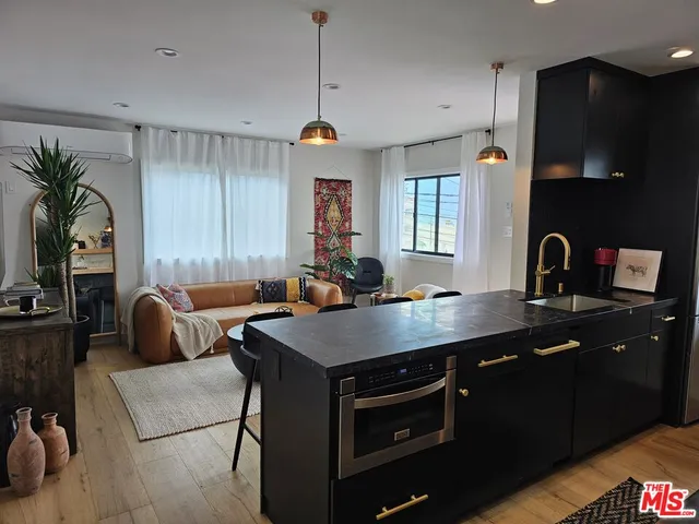 a kitchen with a table chairs sink and window