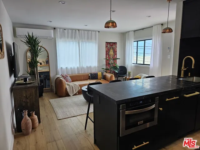a kitchen with a table chairs and a refrigerator