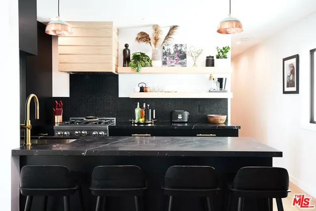 a kitchen with a sink cabinets and appliances