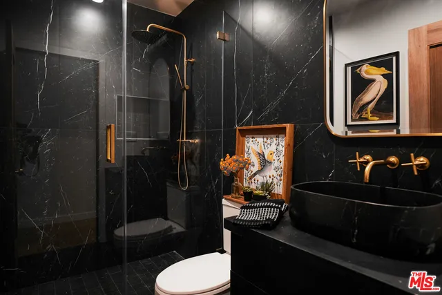 a bathroom with a sink toilet and shower