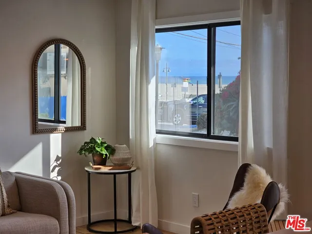 a living room with furniture and potted plant
