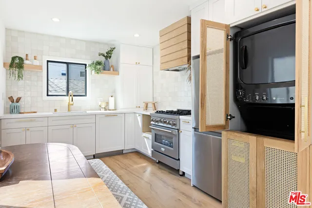 a kitchen with stainless steel appliances kitchen island granite countertop a sink and cabinets
