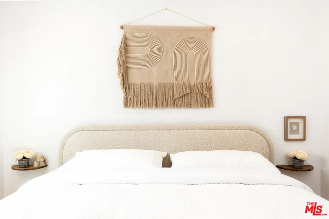 a bedroom with a bed and a mirror