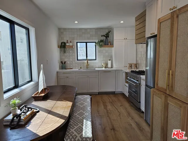 a kitchen with a sink appliances and cabinets