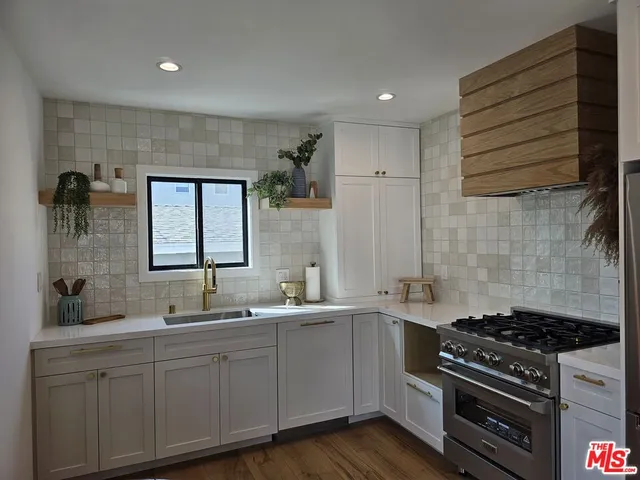 a kitchen with a sink stove and cabinets