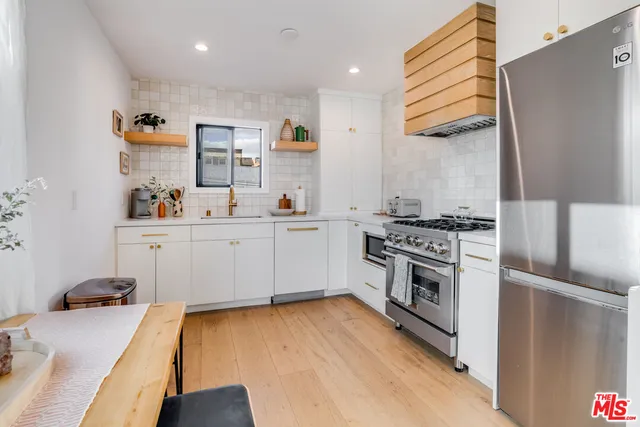 a kitchen with a sink appliances and cabinets