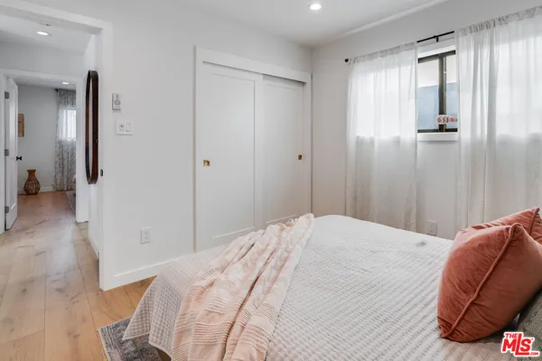 a bedroom with a bed and a mirror