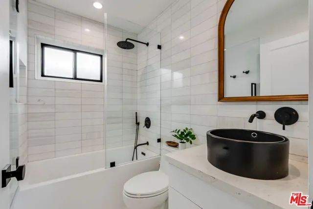 a bathroom with a toilet a sink and bathtub