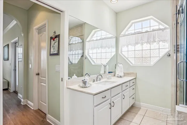 a bathroom with a granite countertop sink a toilet and a mirror