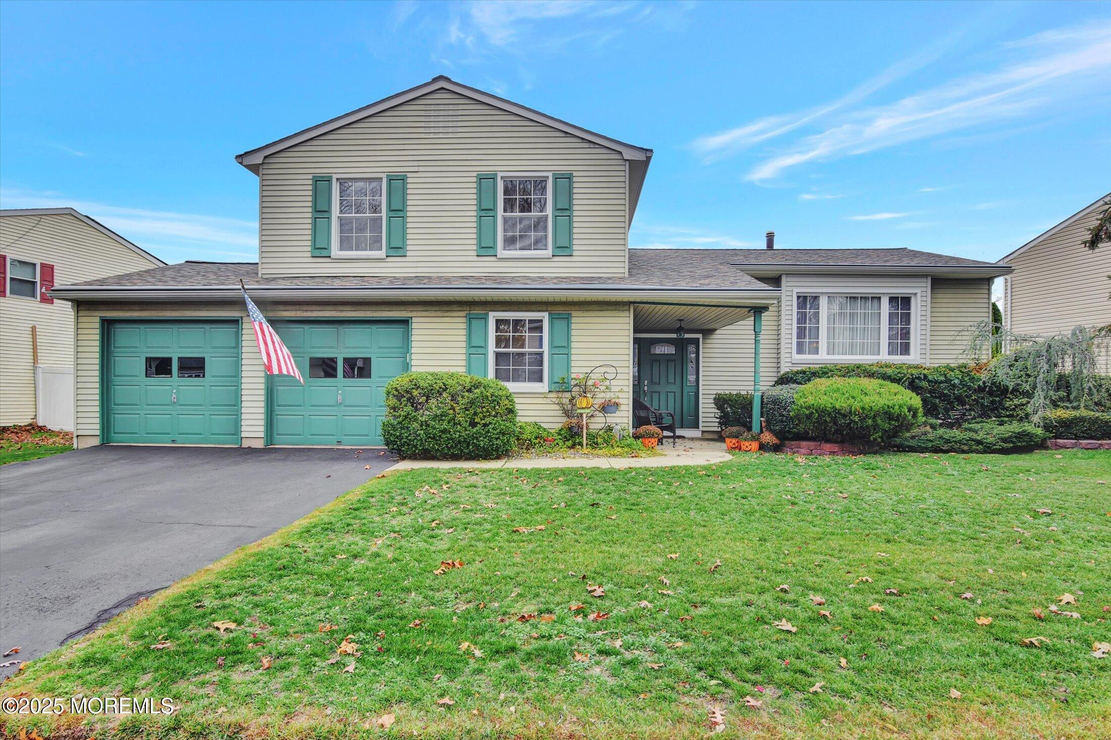 a front view of a house with a yard and garage