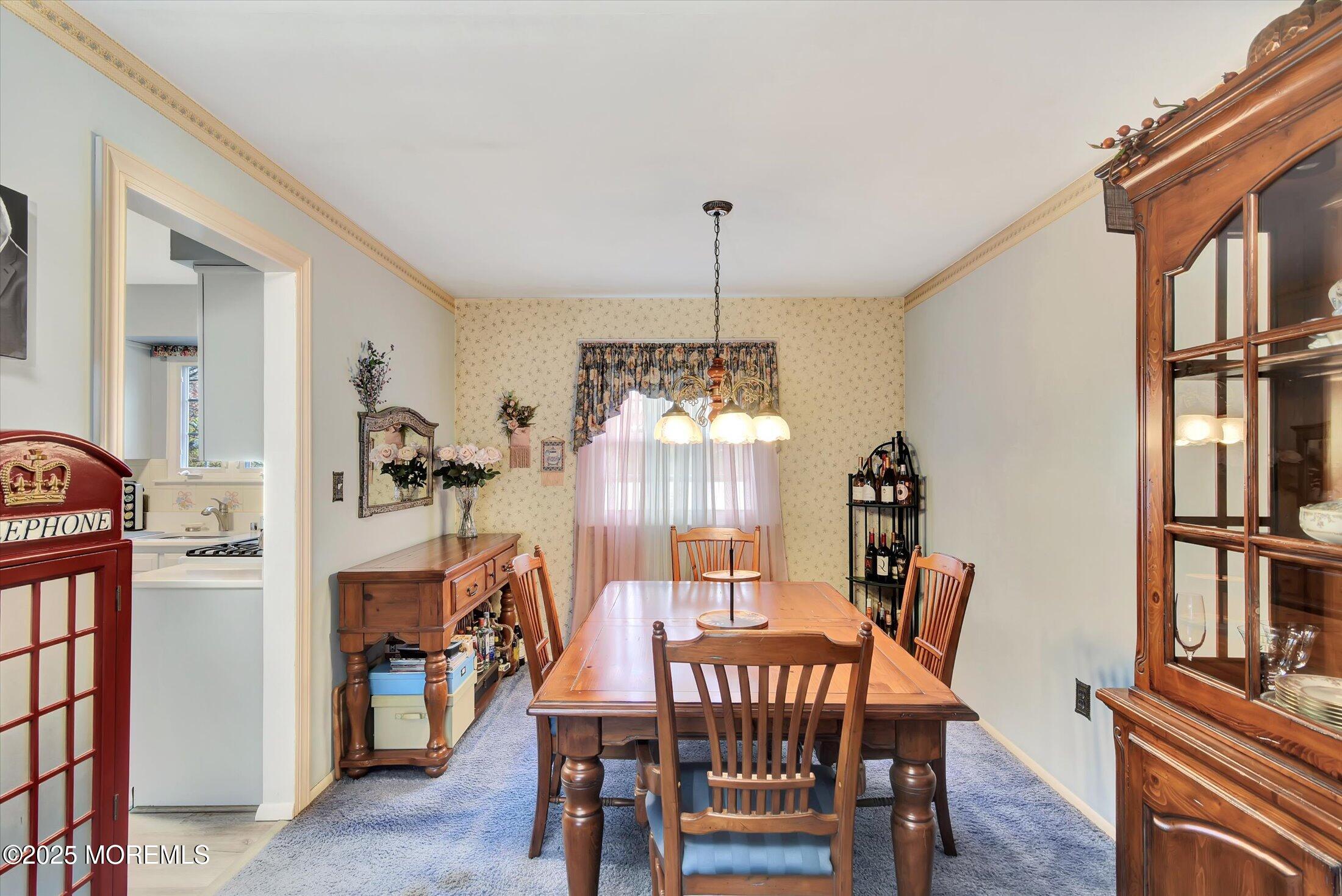 7 Nantucket Court Howell, NJ 07731 - Photo 11 of 39 a view of a dining room with furniture and a chandelier