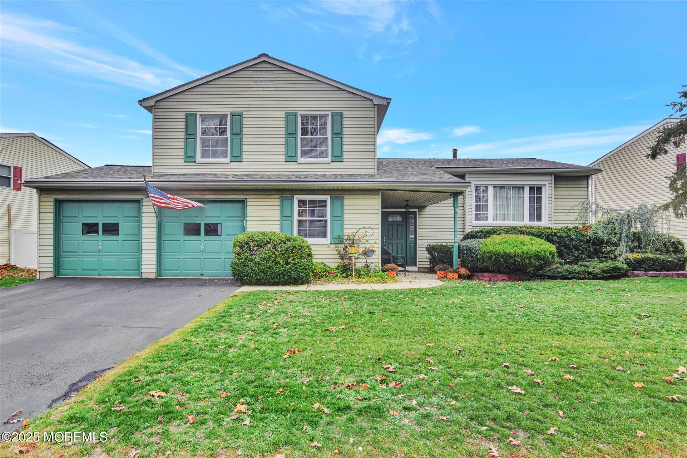 7 Nantucket Court Howell, NJ 07731 - Photo 2 of 39 a front view of a house with porch and garden