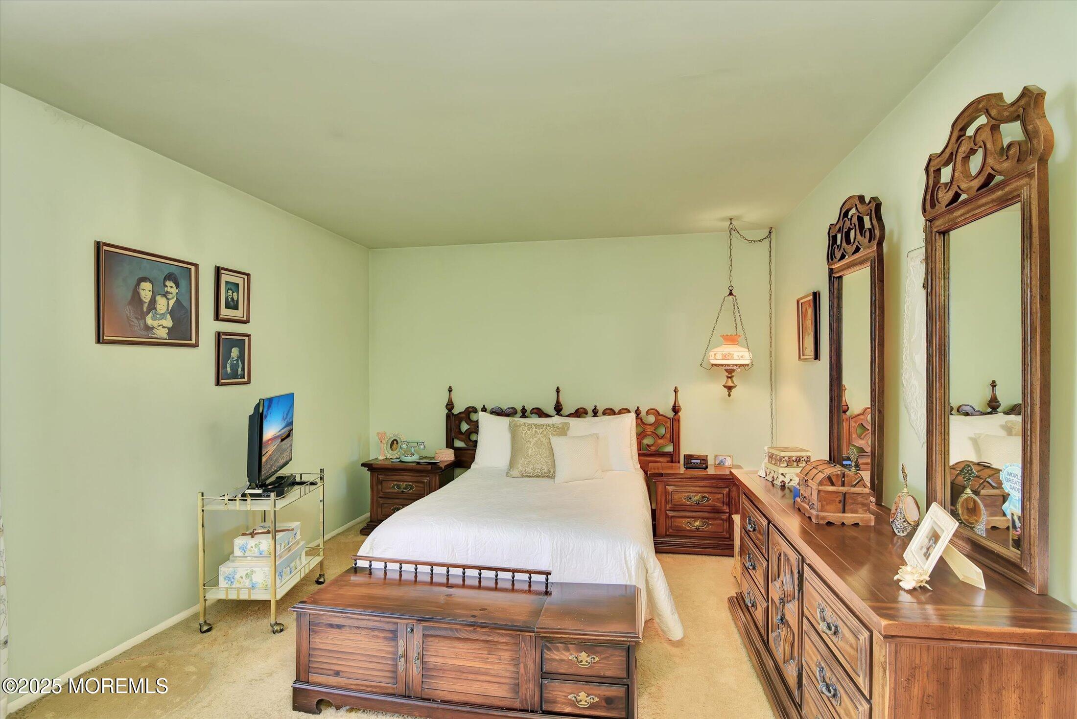 7 Nantucket Court Howell, NJ 07731 - Photo 27 of 39 a bedroom with a bed and wooden floor