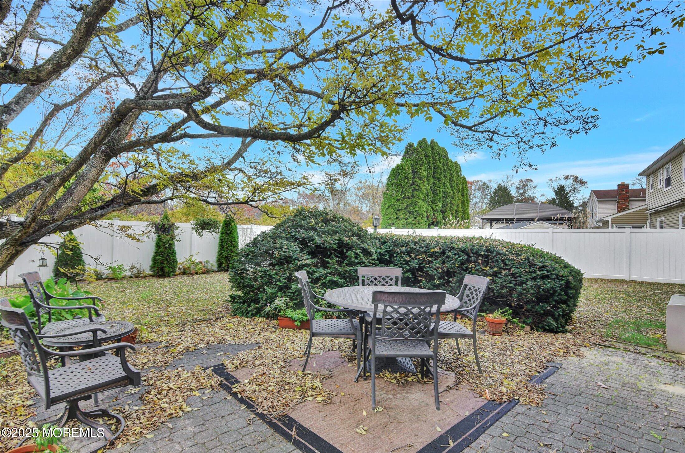 7 Nantucket Court Howell, NJ 07731 - Photo 32 of 39 a backyard of a house with a yard and outdoor seating