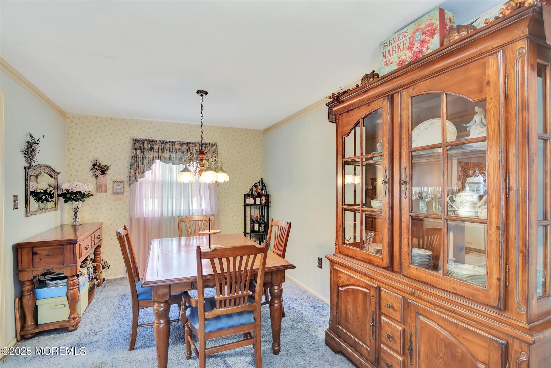 7 Nantucket Court Howell, NJ 07731 - Photo 10 of 39 a view of a dining room with furniture wooden floor and a chandelier