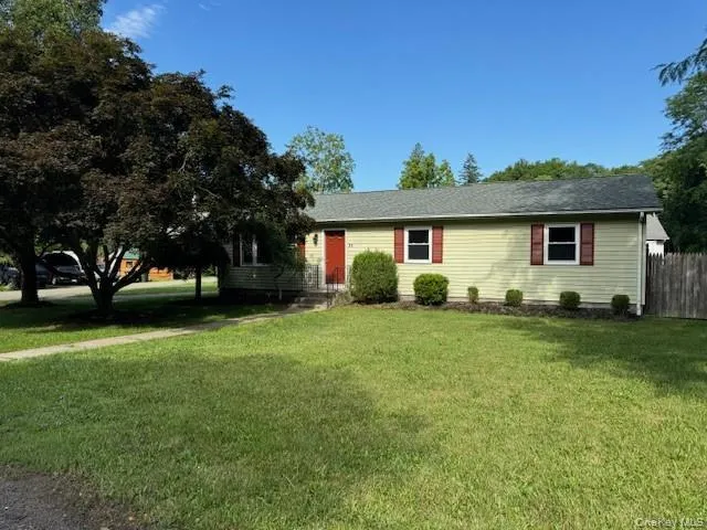 a front view of house with a garden