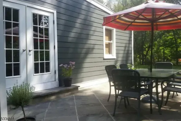 a view of a house with backyard and sitting area