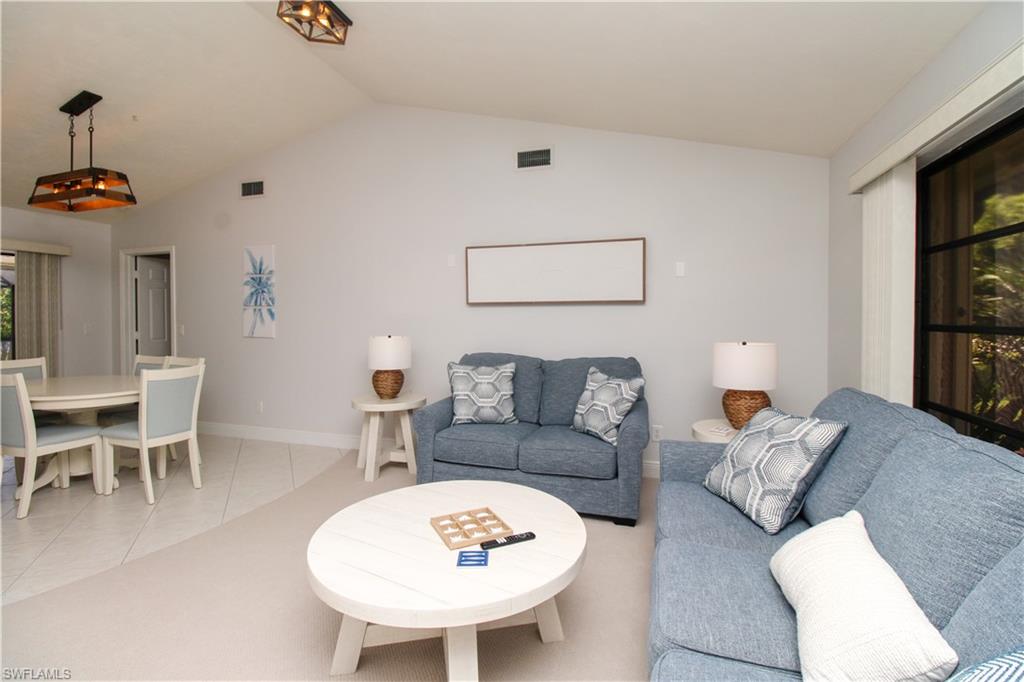213 Bay Meadows Drive Naples, FL 34113 - Photo 12 of 50 a living room with furniture and a table