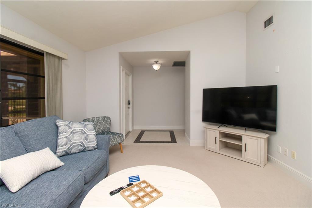 213 Bay Meadows Drive Naples, FL 34113 - Photo 14 of 50 a living room with furniture and a flat screen tv