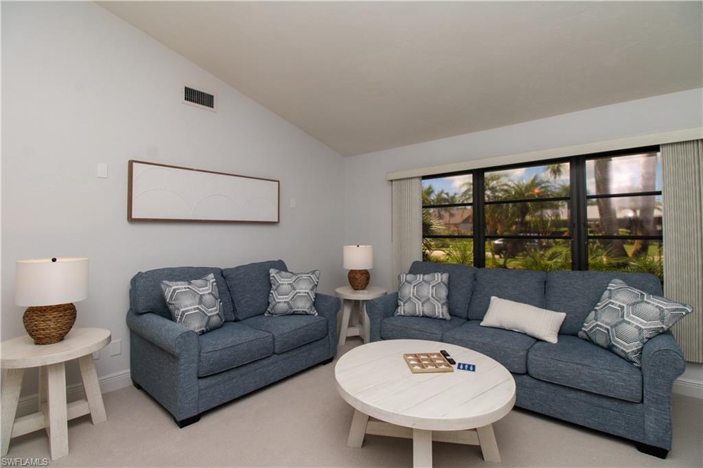 213 Bay Meadows Drive Naples, FL 34113 - Photo 15 of 50 a living room with furniture and a large window