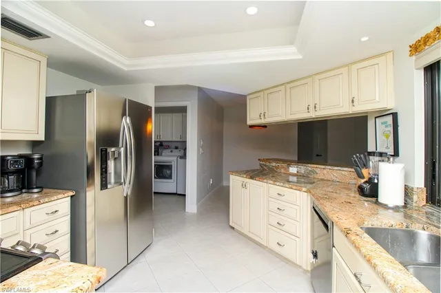 a kitchen with stainless steel appliances granite countertop a refrigerator and a sink